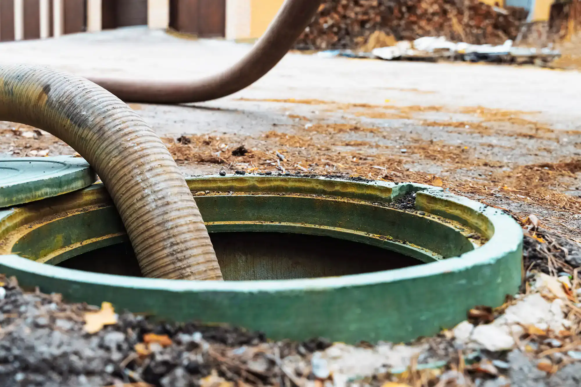 Professional septic tank service in Cook County, Illinois by All Rooter Hydro Jetting, pumping a green septic tank hole with advanced equipment for thorough waste removal and cleaning