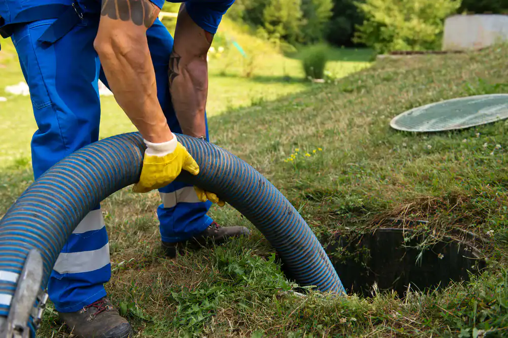 Skilled technician operating a heavy-duty septic hose on a Cook County property, ensuring professional waste removal and maintenance for All Rooter Hydro Jetting Experts